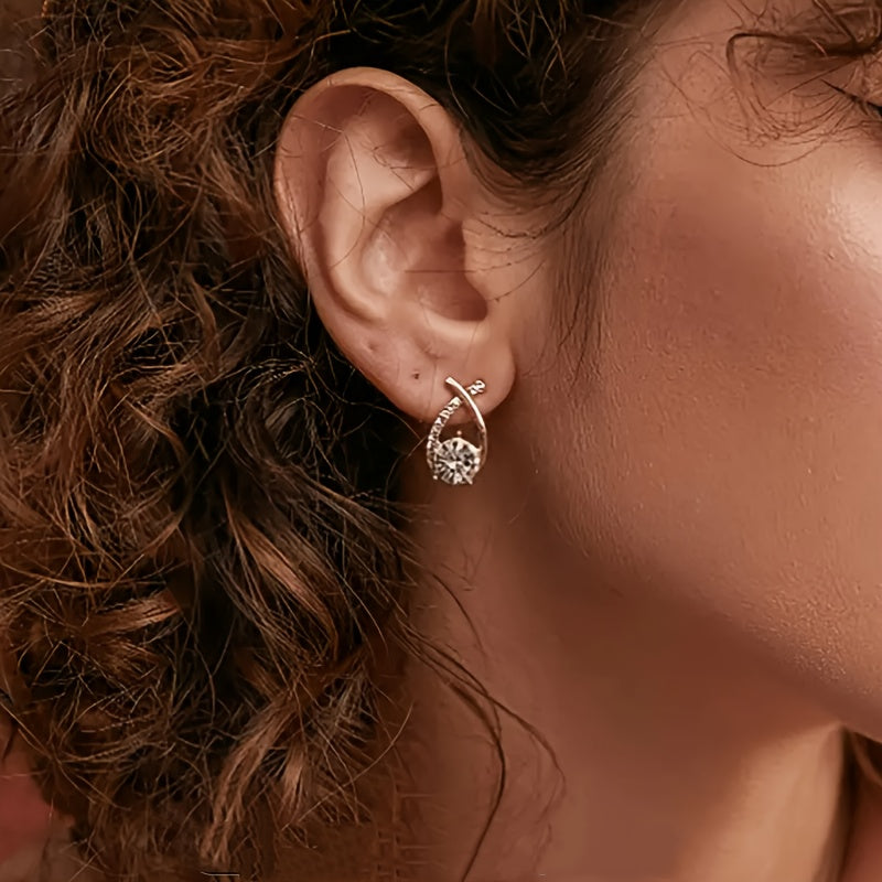Pin earrings with a gold cross and zirconia