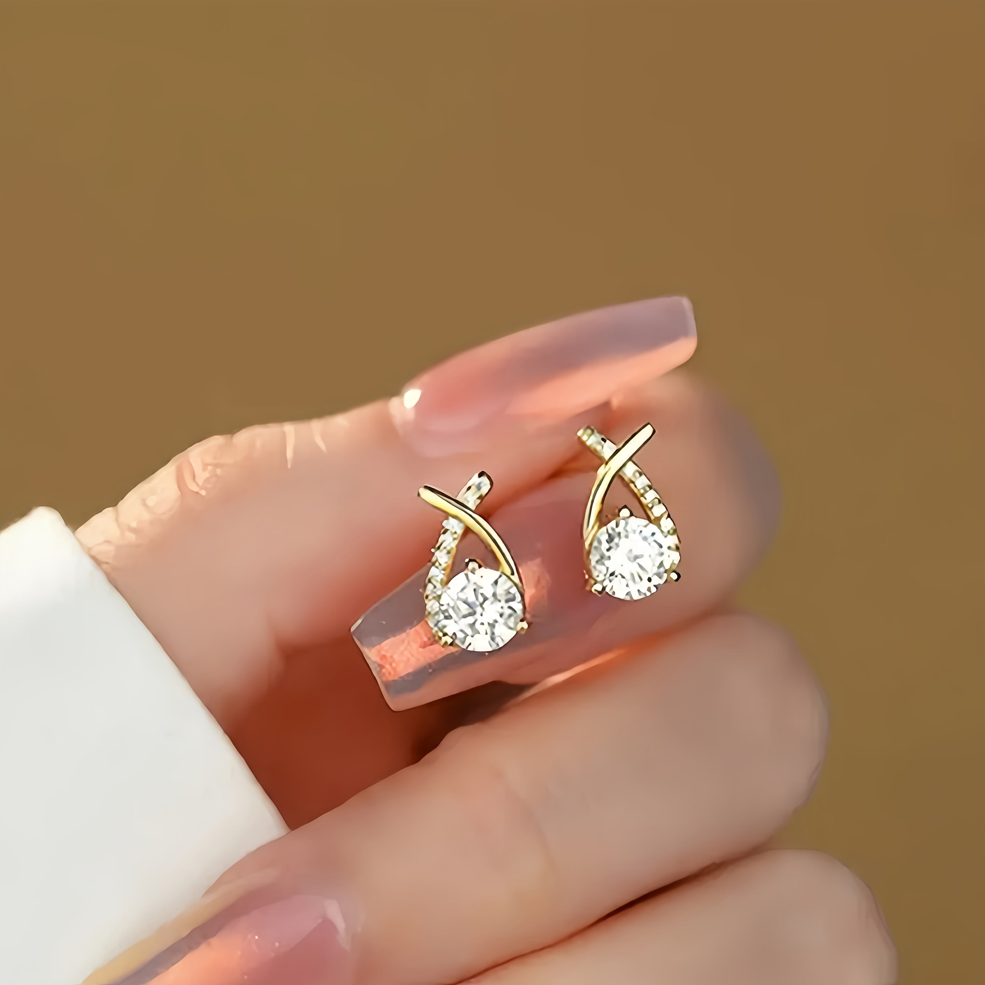 Pin earrings with a gold cross and zirconia