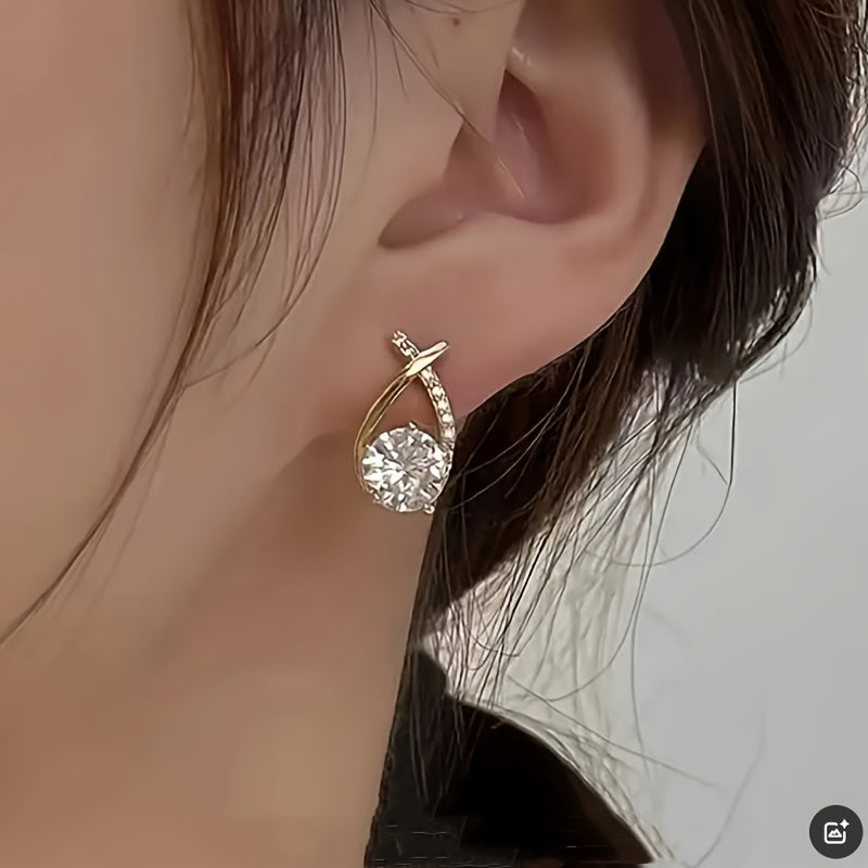 Pin earrings with a gold cross and zirconia