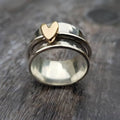 Silver ring with a gold heart