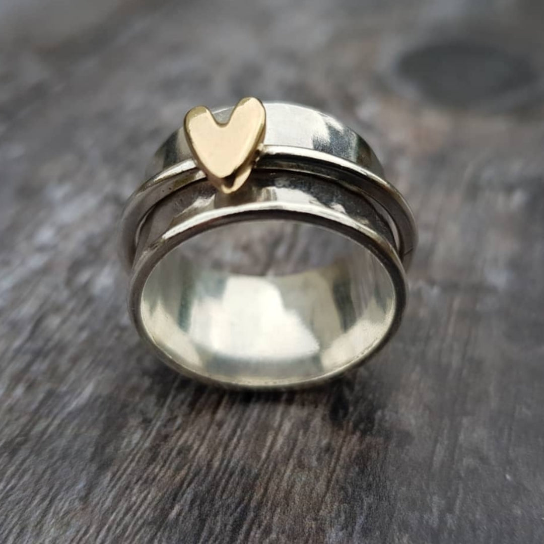 Silver ring with a gold heart