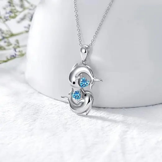 Silver collar with double dolphins and blue crystal stone