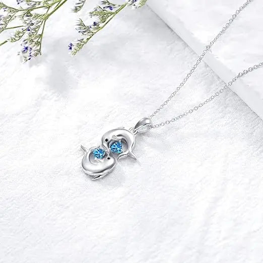 Silver collar with double dolphins and blue crystal stone