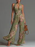 Green floral print jumpsuit with a V-neck, sleeveless, with a zipper and pleats, wide leg